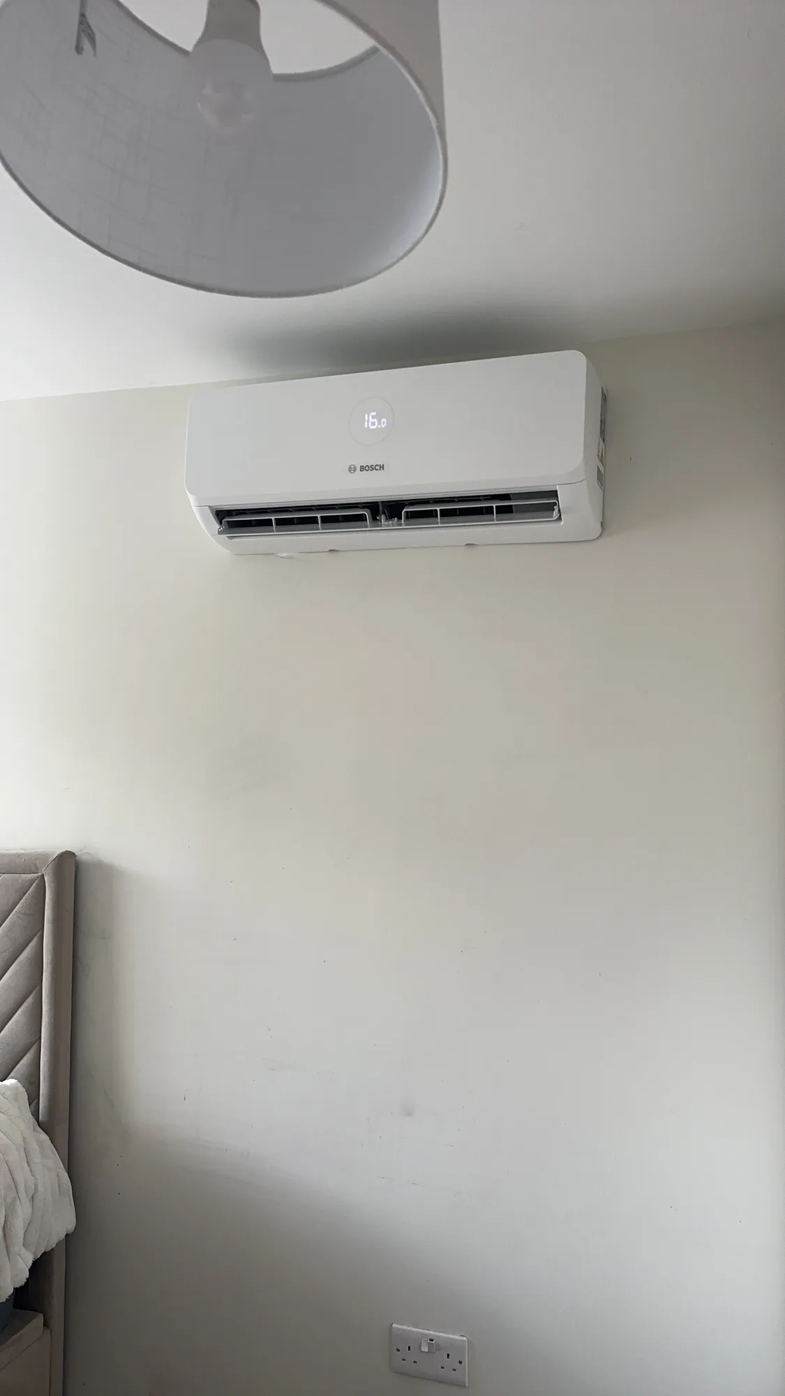 Wall-mounted air conditioning indoor split unit in a bedroom