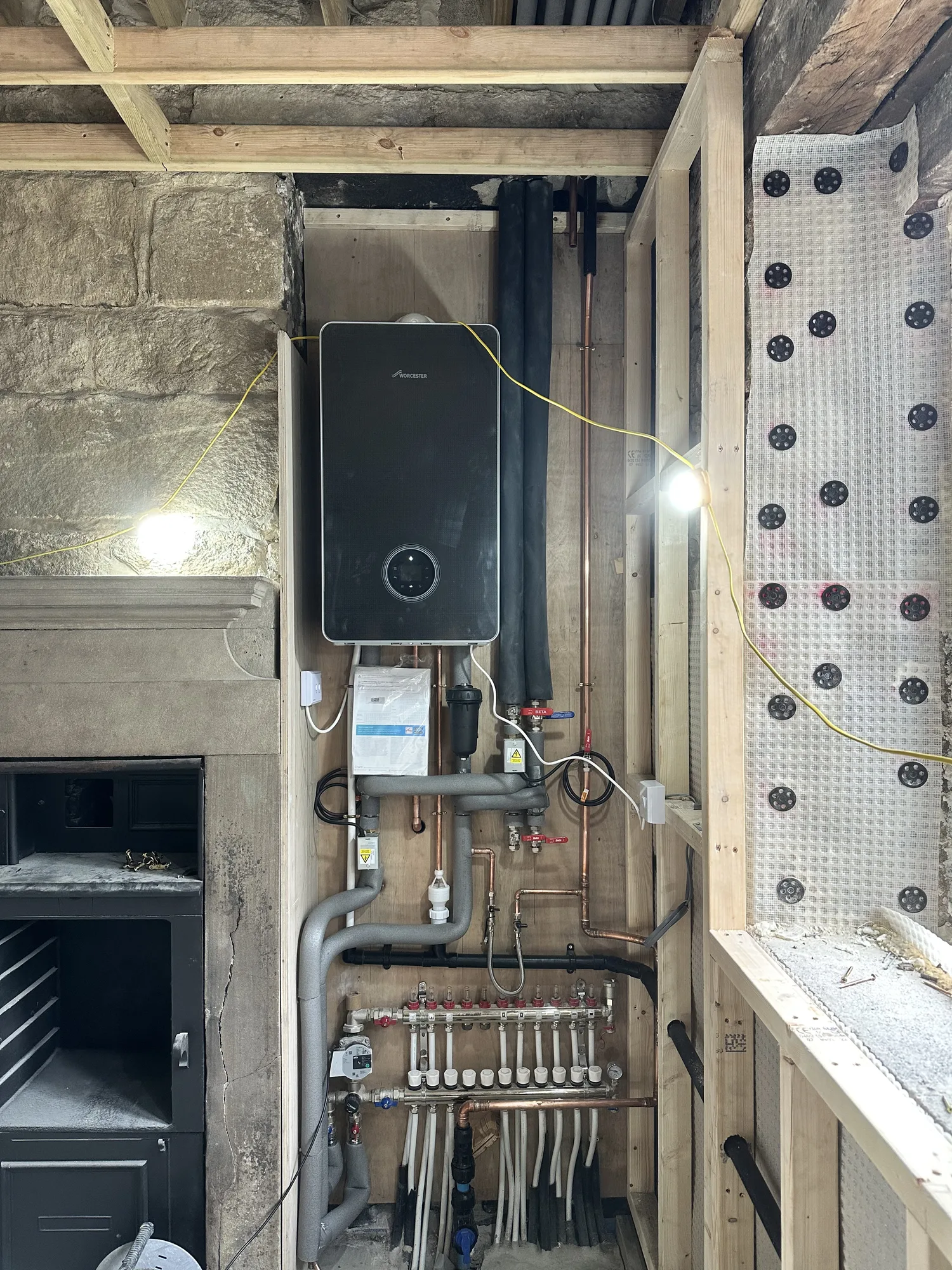Gas boiler installed above an underfloor heating manifold