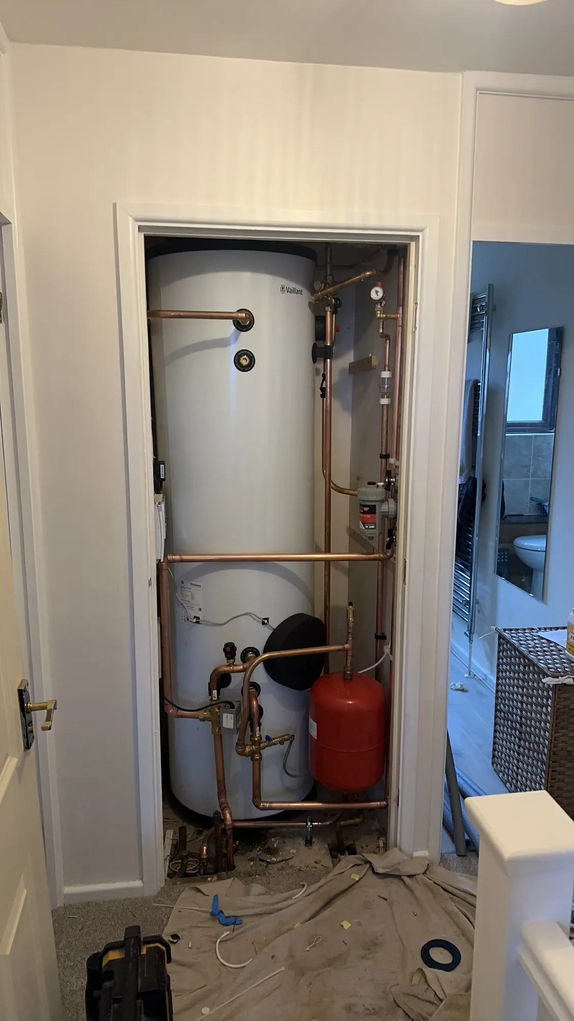 Heat pump hot water cylinder with buffer tank, red expansion vessel and grey pipework