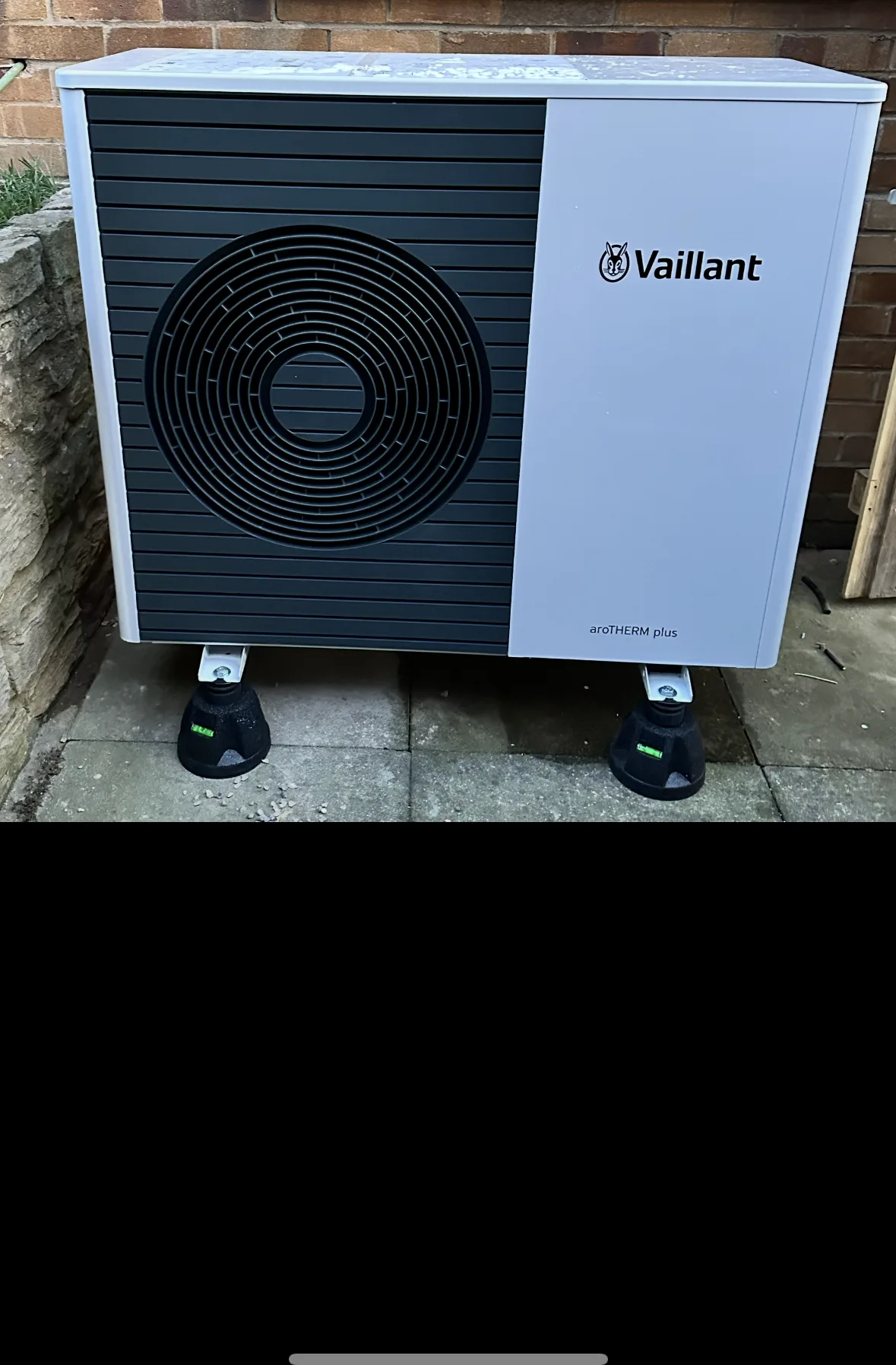 Vaillant air source heat pump outdoor unit on a paved base