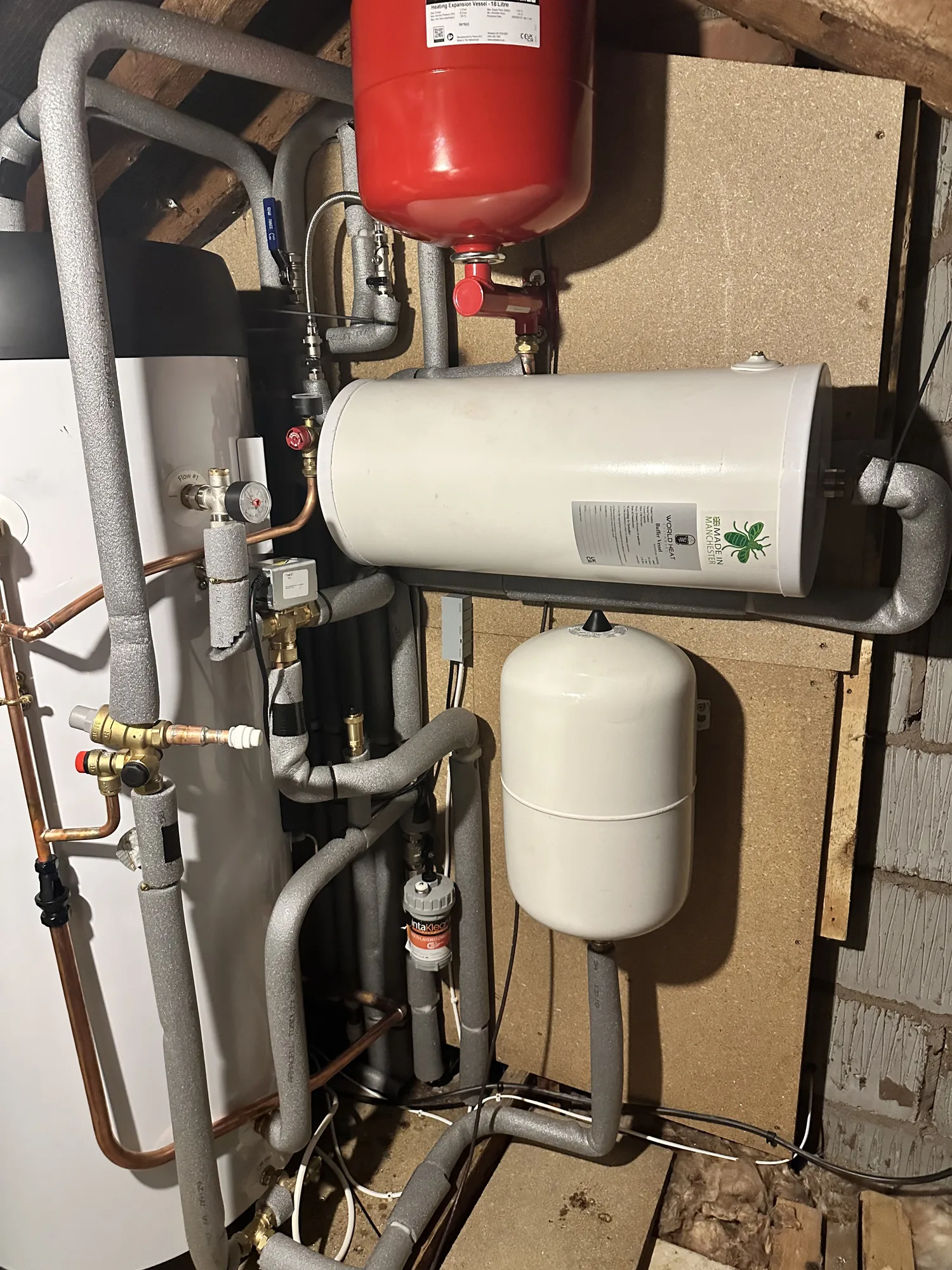 Heat pump buffer tank and expansion vessels with grey and copper pipework